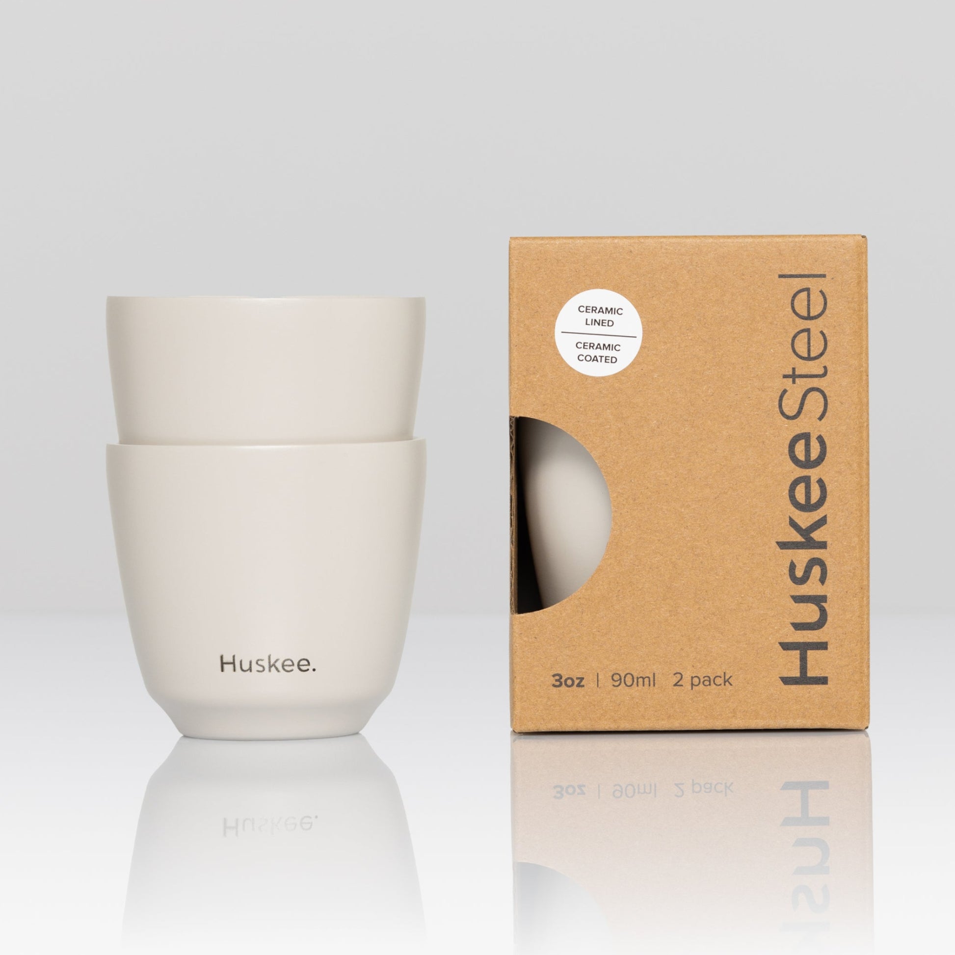 Set of 2 HuskeeSteel 3oz espresso cups crafted from 91% recycled double-wall vacuum insulated stainless steel in white with box.