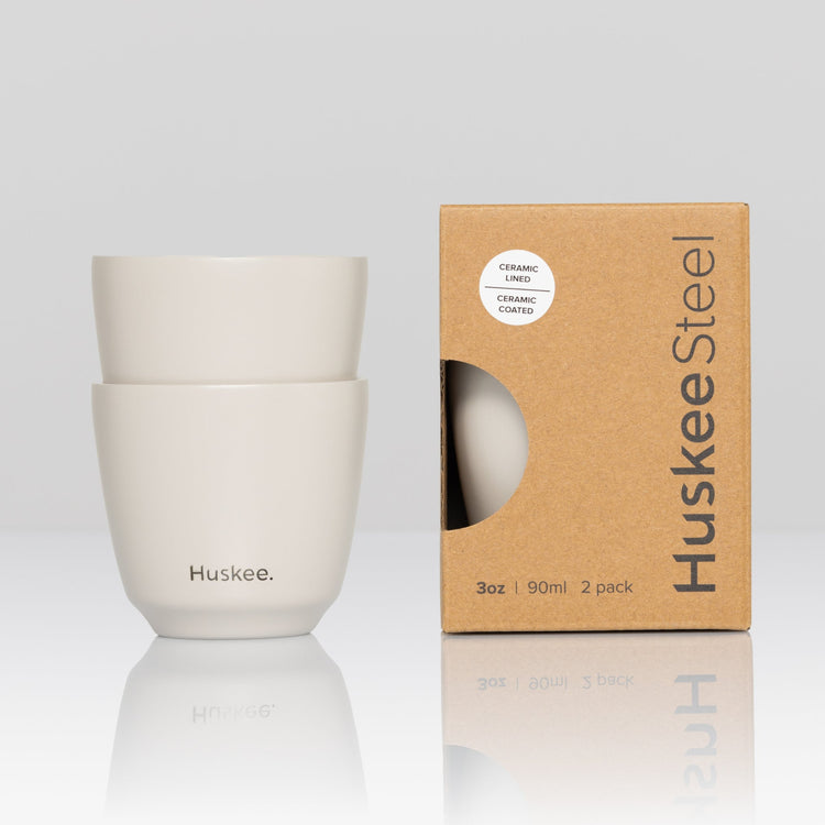 Set of 2 HuskeeSteel 3oz espresso cups crafted from 91% recycled double-wall vacuum insulated stainless steel in white with box.