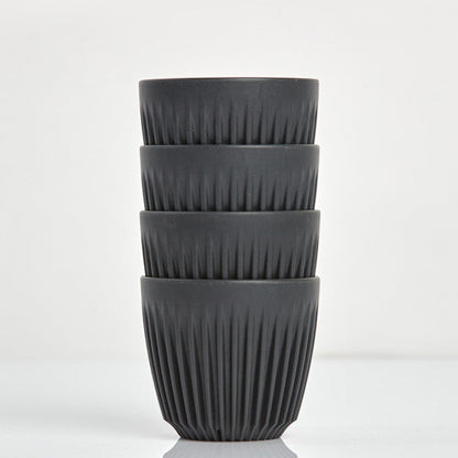 A 6oz HuskeeOriginal reusable coffee cup featuring signature ribbed design made from coffee husk waste charcoal 4 pack.