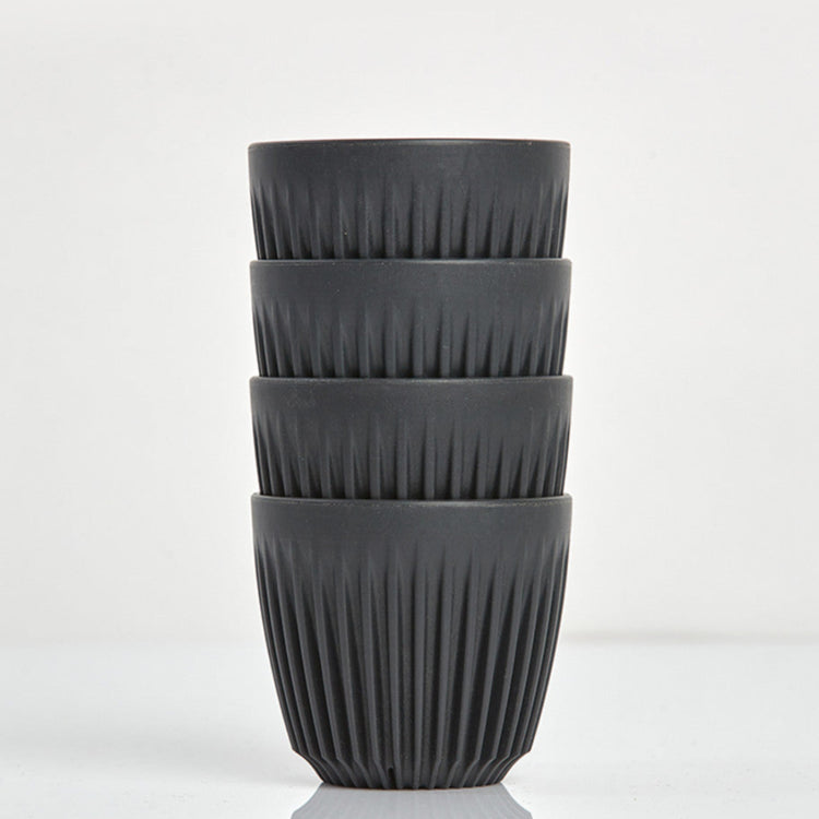 A 6oz HuskeeOriginal reusable coffee cup featuring signature ribbed design made from coffee husk waste charcoal 4 pack.