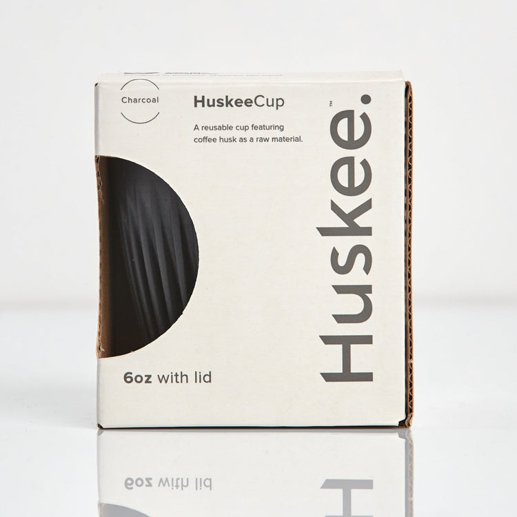 A 6oz HuskeeOriginal reusable coffee cup featuring signature ribbed design made from coffee husk waste charcoal in box.