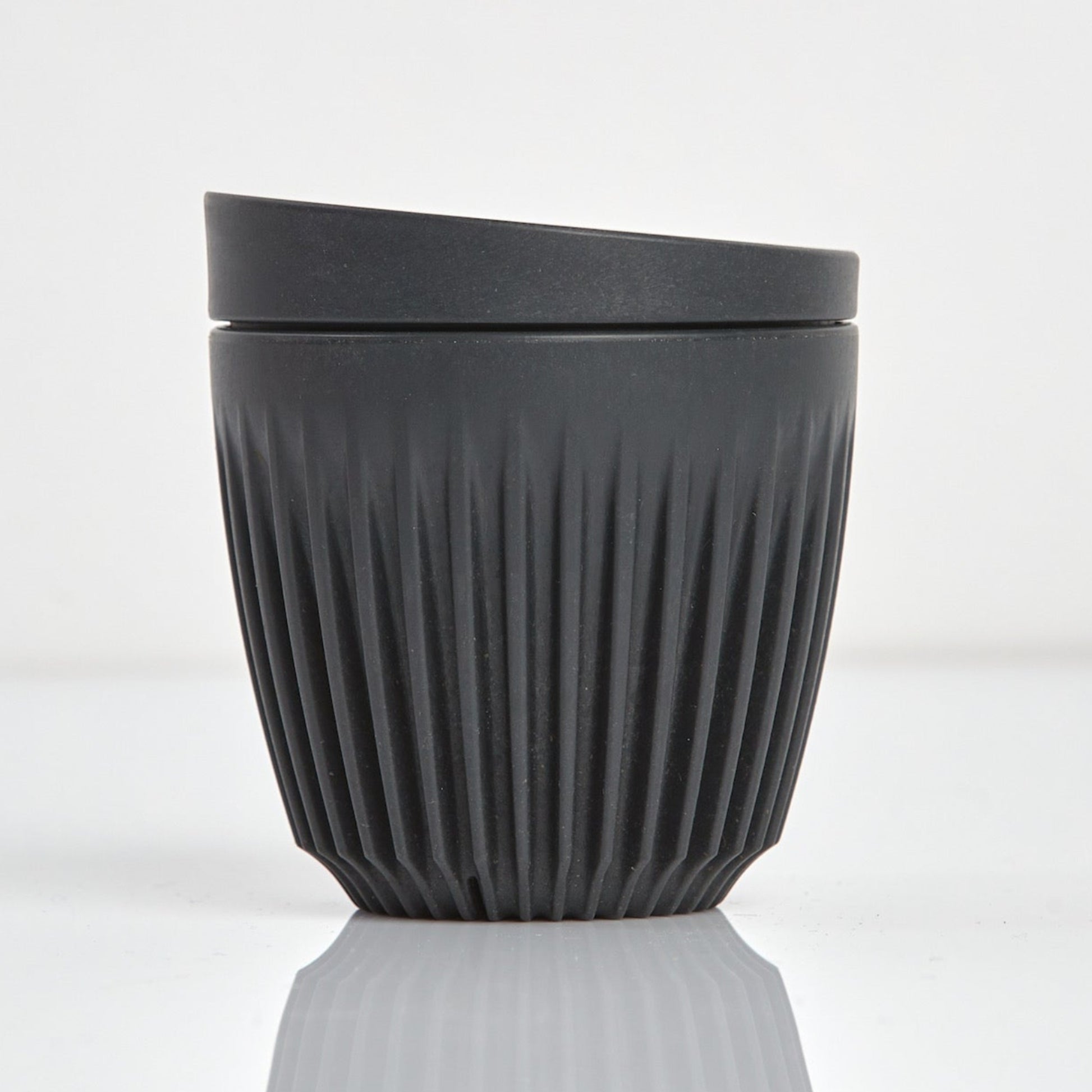 A 6oz HuskeeOriginal reusable coffee cup featuring signature ribbed design made from sustainable coffee husk waste charcoal.