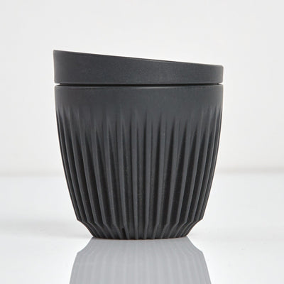 A 6oz HuskeeOriginal reusable coffee cup featuring signature ribbed design made from sustainable coffee husk waste charcoal.