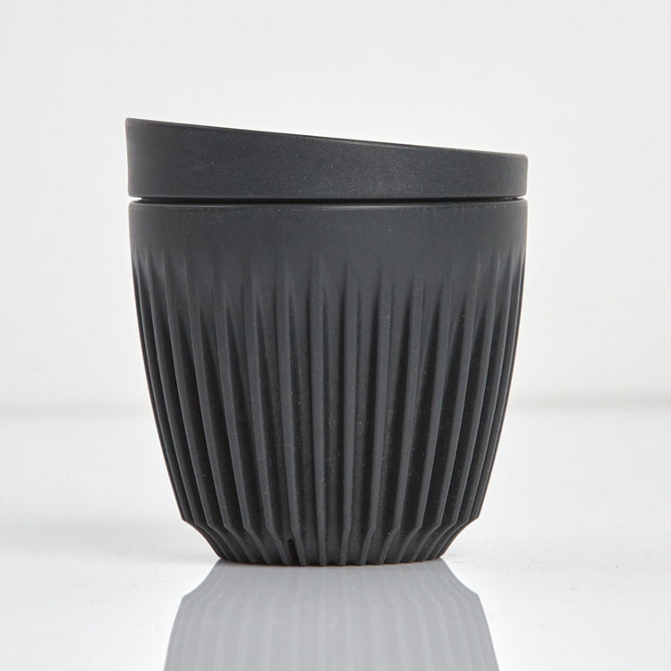 A 6oz HuskeeOriginal reusable coffee cup featuring signature ribbed design made from sustainable coffee husk waste charcoal.