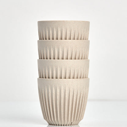 A 6oz HuskeeOriginal reusable coffee cup featuring the signature ribbed design made from coffee husk waste natural 4 pack.