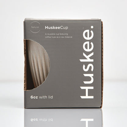 A 6oz HuskeeOriginal reusable coffee cup featuring signature ribbed design made from coffee husk waste natural in box.