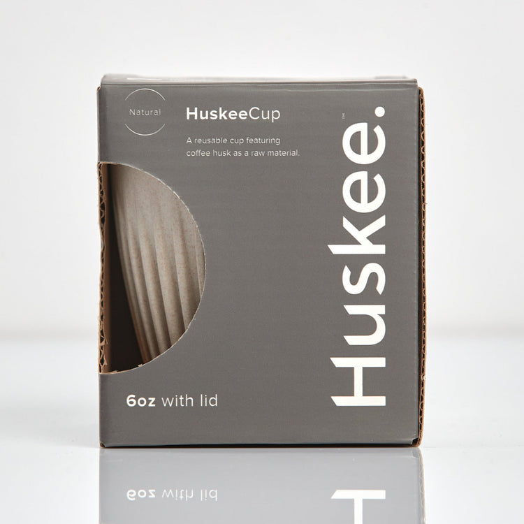 A 6oz HuskeeOriginal reusable coffee cup featuring signature ribbed design made from coffee husk waste natural in box.