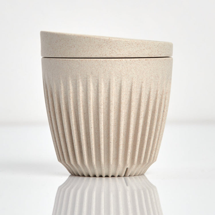 A 6oz HuskeeOriginal reusable coffee cup featuring signature ribbed design made from sustainable coffee husk waste natural.