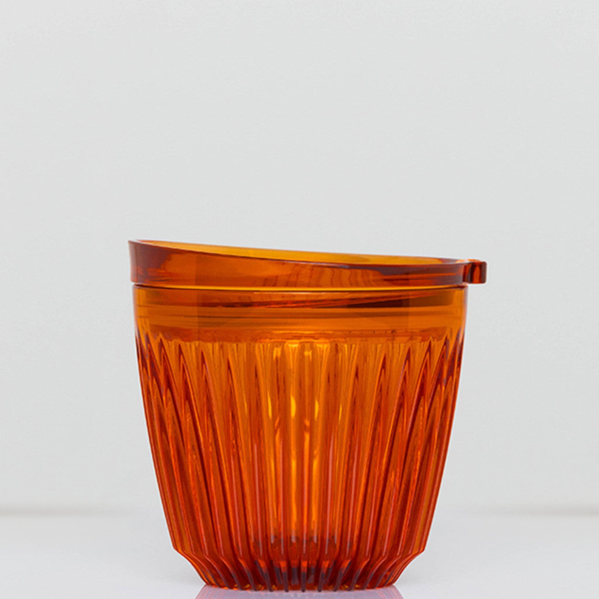 A small 6oz HuskeeRenew translucent reusable coffee cup made from high-performance recycled polymer in amber.