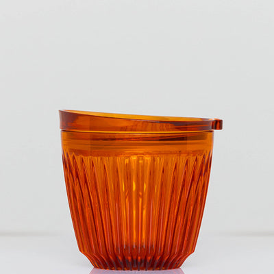 A small 6oz HuskeeRenew translucent reusable coffee cup made from high-performance recycled polymer in amber.