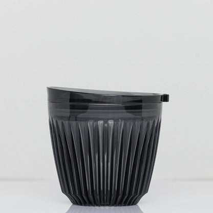 A small 6oz HuskeeRenew translucent reusable coffee cup made from high-performance recycled polymer in smoke.