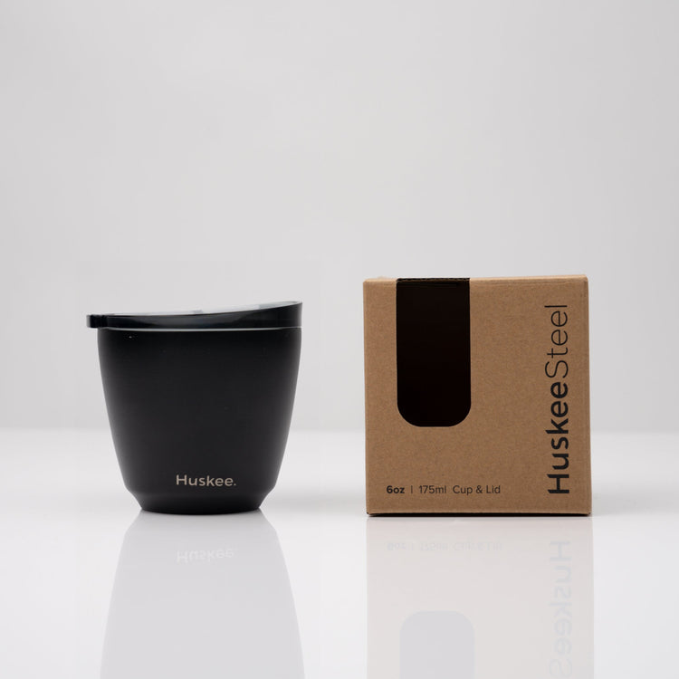 Small 6oz HuskeeSteel reusable coffee cup with matching stopper lid made from vacuum insulated stainless steel in black with box.