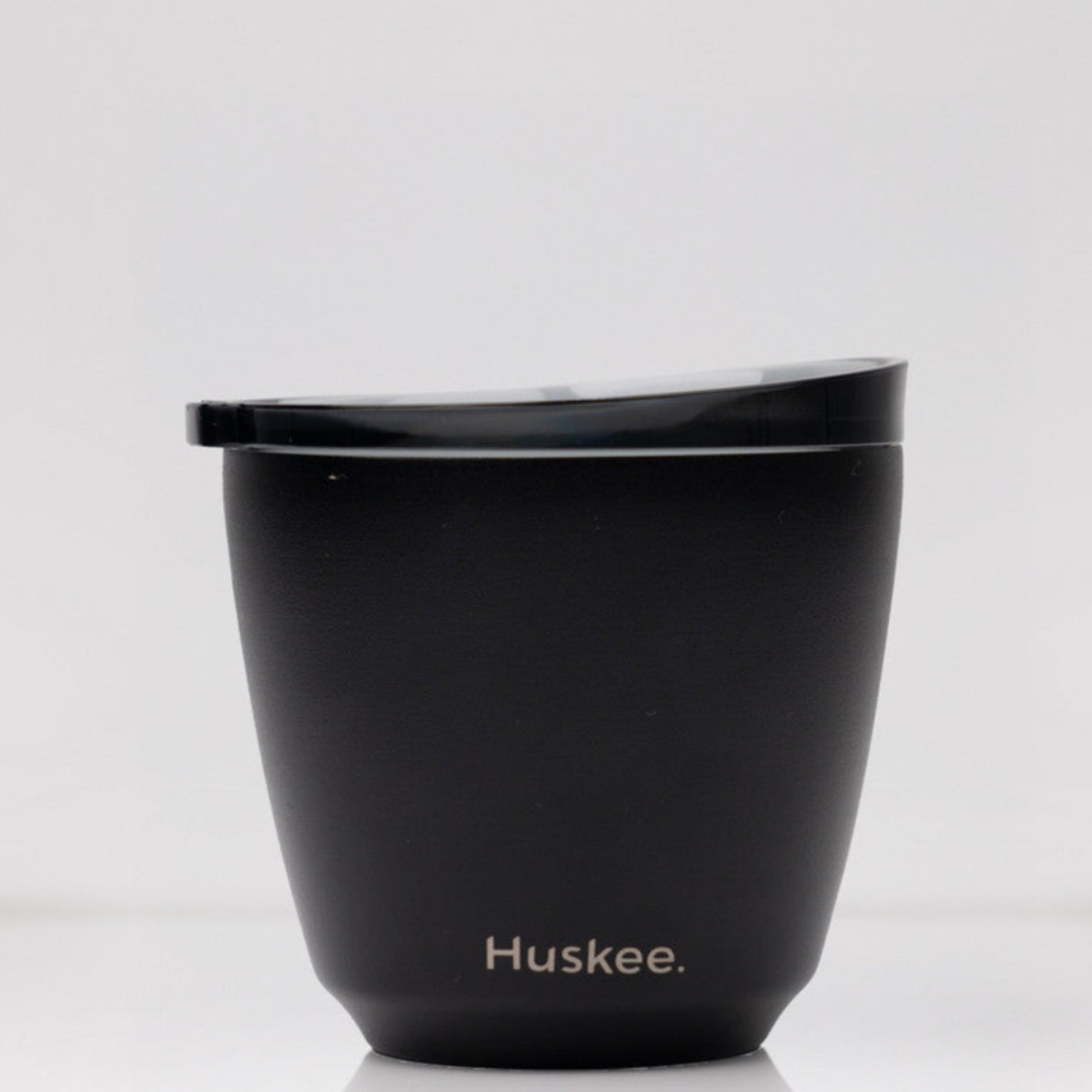 Small 6oz HuskeeSteel reusable coffee cup with matching stopper lid made from vacuum insulated stainless steel in black.