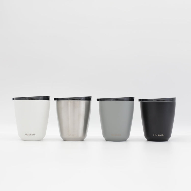 Four 6oz HuskeeSteel reusable coffee cups with matching stopper lid in the four colours available.