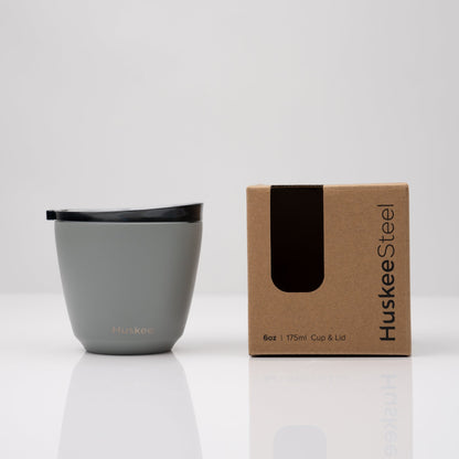 Small 6oz HuskeeSteel reusable coffee cup with matching stopper lid made from vacuum insulated stainless steel in slate with box.
