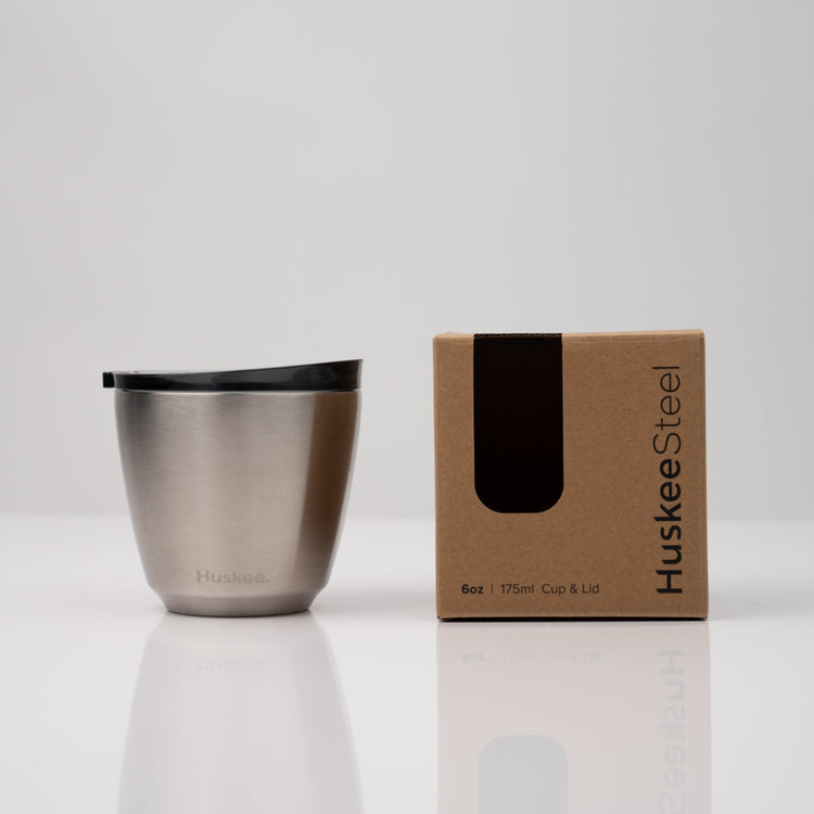 Small 6oz HuskeeSteel reusable coffee cup with matching stopper lid made from 91% recycled stainless steel in steel with box.