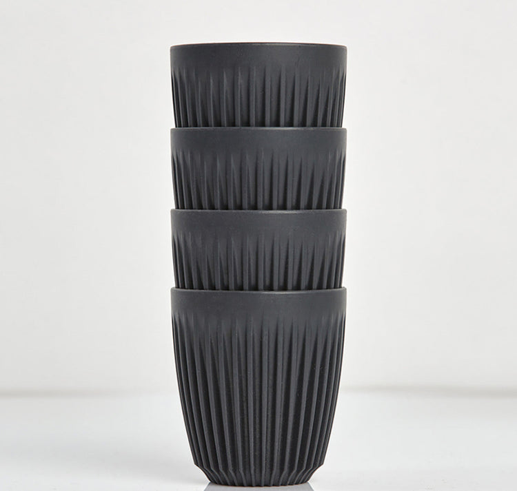 Standard 8oz HuskeeOriginal reusable coffee cup featuring the signature vertical ribbed design made from sustainable coffee husk waste in charcoal 4 pack.