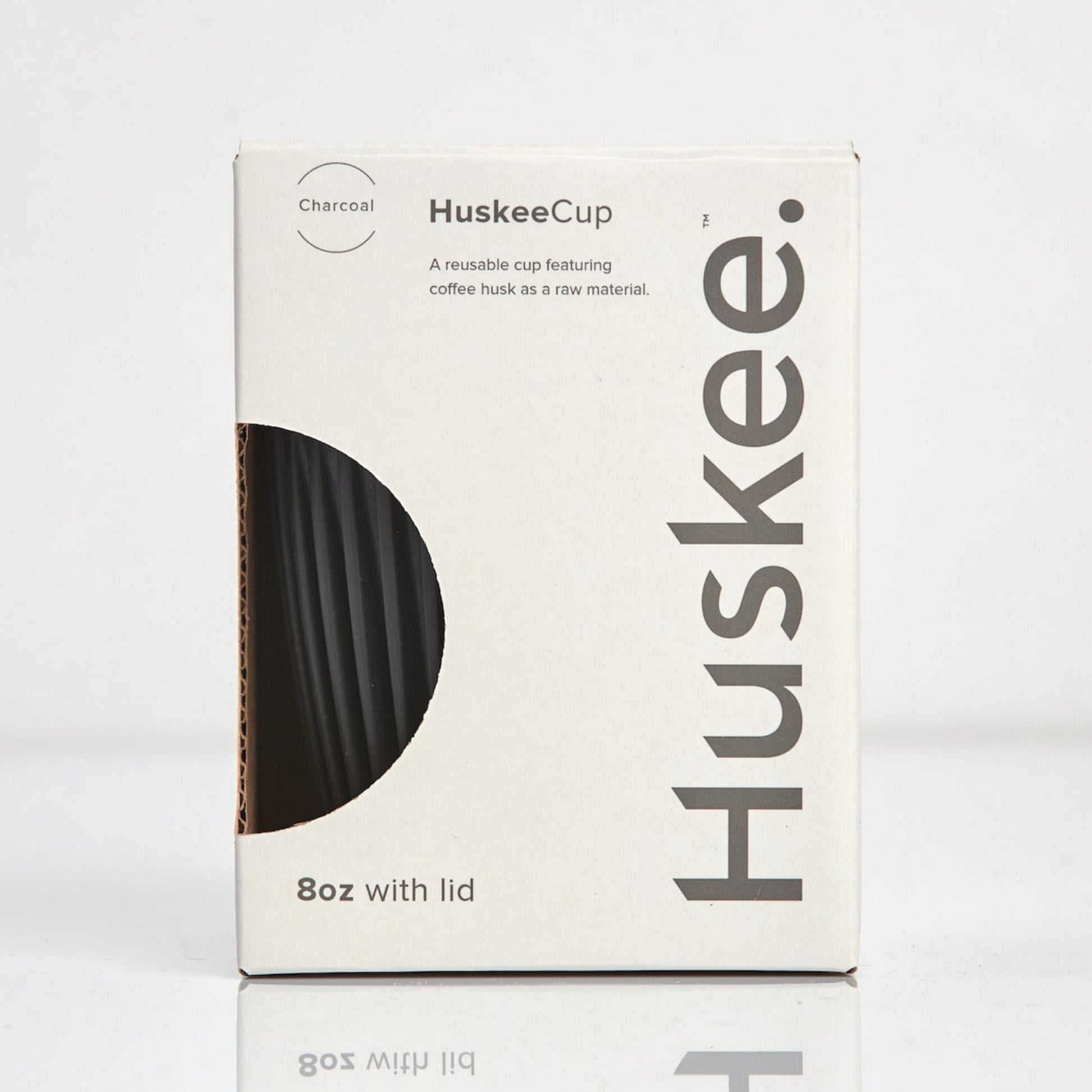 Standard 8oz HuskeeOriginal reusable coffee cup featuring the signature vertical ribbed design made from sustainable coffee husk waste in charcoal in box.