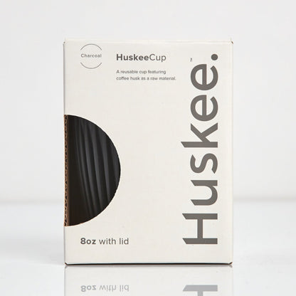 Standard 8oz HuskeeOriginal reusable coffee cup featuring the signature vertical ribbed design made from sustainable coffee husk waste in charcoal in box.