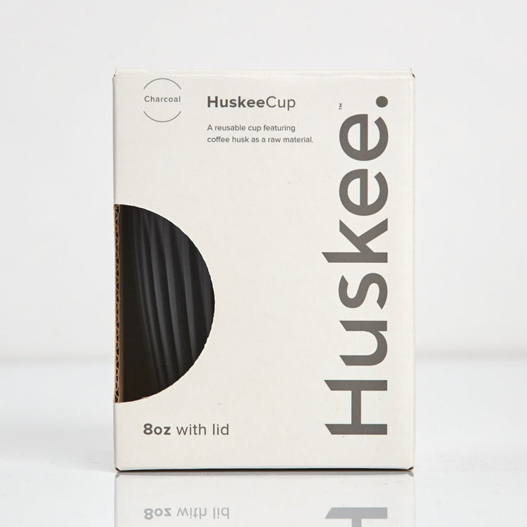 Standard 8oz HuskeeOriginal reusable coffee cup featuring the signature vertical ribbed design made from sustainable coffee husk waste in charcoal in box.