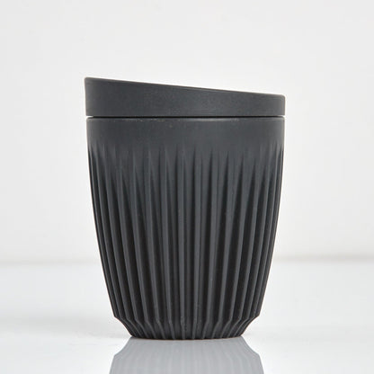 Standard 8oz HuskeeOriginal reusable coffee cup featuring the signature vertical ribbed design made from sustainable coffee husk waste n charcoal.