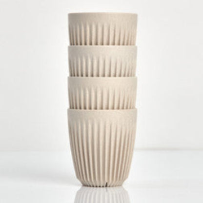 Standard 8oz HuskeeOriginal reusable coffee cup featuring the signature vertical ribbed design made from sustainable coffee husk waste in natural 4 pack.