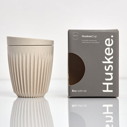 Standard 8oz HuskeeOriginal reusable coffee cup featuring the signature vertical ribbed design made from sustainable coffee husk waste in natural with box.