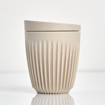 Standard 8oz HuskeeOriginal reusable coffee cup featuring the signature vertical ribbed design made from sustainable coffee husk waste in natural.