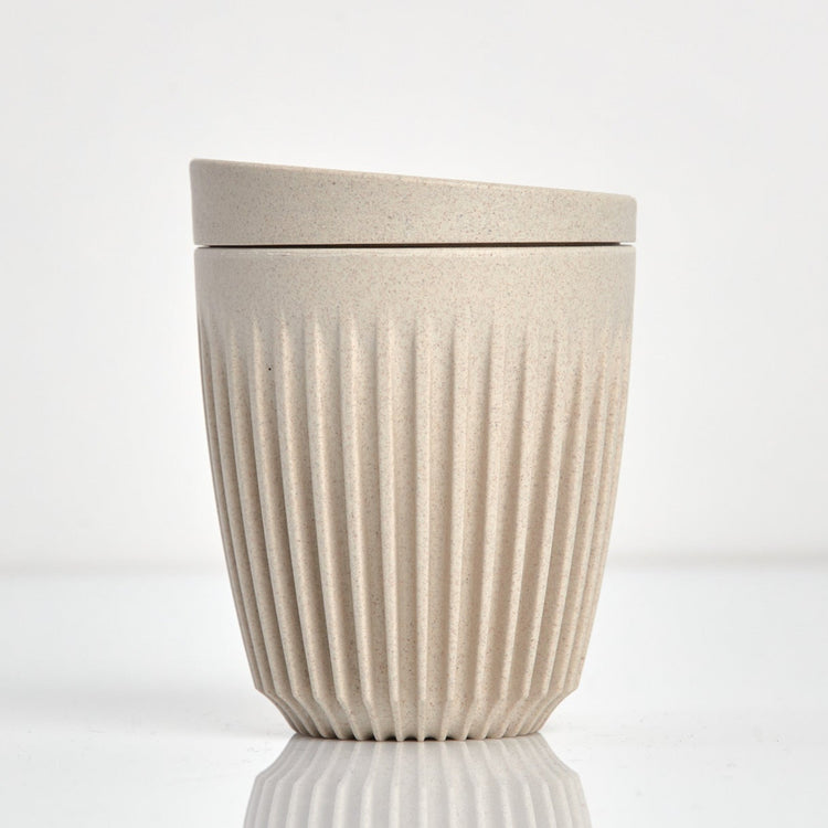 Standard 8oz HuskeeOriginal reusable coffee cup featuring the signature vertical ribbed design made from sustainable coffee husk waste in natural.