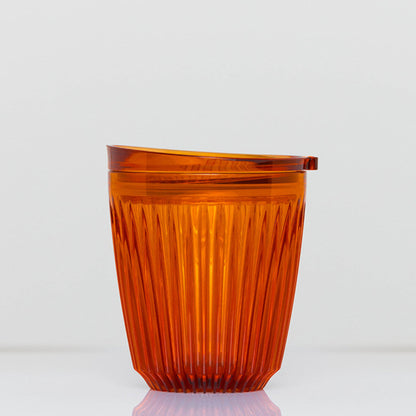 Standard 8oz HuskeeRenew translucent reusable coffee cup featuring the signature vertical ribbed design made from high-performance recycled polymer in amber.