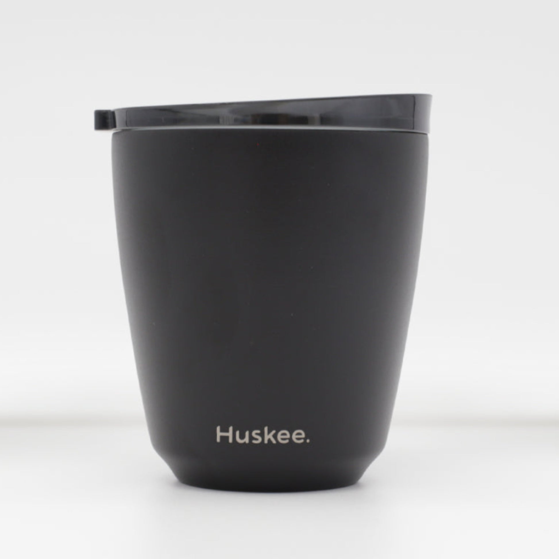 Standard 8oz HuskeeSteel reusable coffee cup with matching stopper lid made from 91% recycled vacuum insulated stainless steel in black.