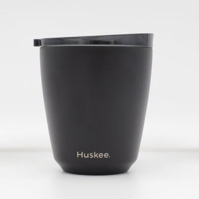 Standard 8oz HuskeeSteel reusable coffee cup with matching stopper lid made from 91% recycled vacuum insulated stainless steel in black.