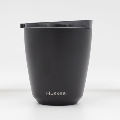 Standard 8oz HuskeeSteel reusable coffee cup with matching stopper lid made from 91% recycled vacuum insulated stainless steel in black.