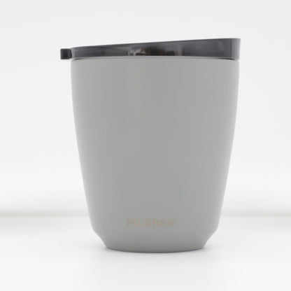 Standard 8oz HuskeeSteel reusable coffee cup with matching stopper lid made from 91% recycled vacuum insulated stainless steel in slate.