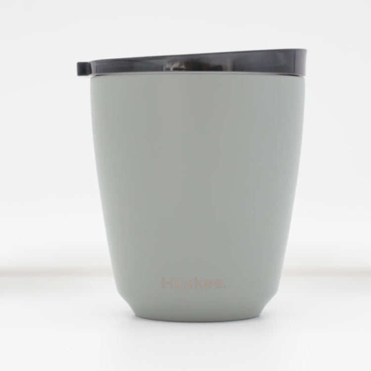Standard 8oz HuskeeSteel reusable coffee cup with matching stopper lid made from 91% recycled vacuum insulated stainless steel in slate.