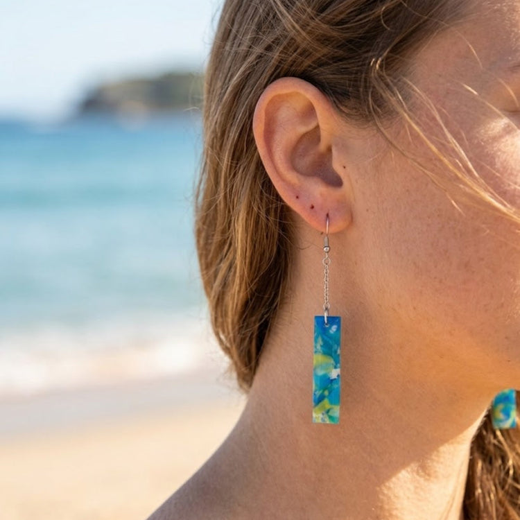 On-model style photo showcasing the fit, movement, and drop length of the upcycled blue and green rectangular chain link earrings in Australia.