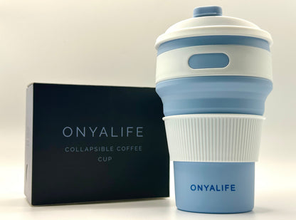 Collapsible 350ml silicone coffee cup with secure lid and heat-protective sleeve, shown expanded and collapsed with its reusable storage pouch. Shown in Powder Blue
