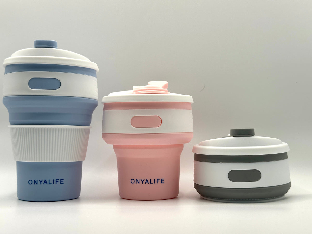 Collapsible 350ml silicone coffee cup with secure lid and heat-protective sleeve, shown expanded and collapsed with its reusable storage pouch. Shown in all 3 colours from fully extended to fully collapsed