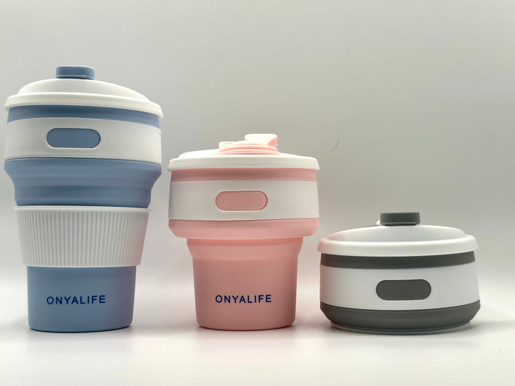 Collapsible 350ml silicone coffee cup with secure lid and heat-protective sleeve, shown expanded and collapsed with its reusable storage pouch. Shown in all 3 colours from fully extended to fully collapsed