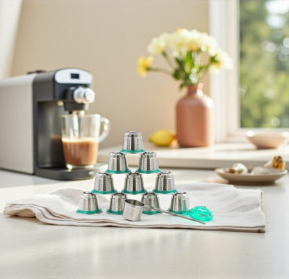 Set of Pod Star Nesspresso Original reusable stainless steel coffee pods  on a kitchen bench with coffee machine in the background