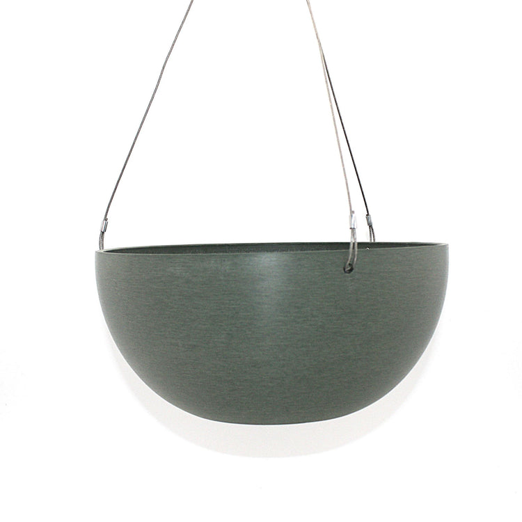 A hanging planter suspended by marine wire against a plain white background. Made from recycled plastic. Shown in Olive