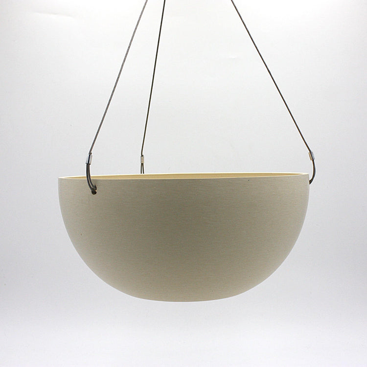 A hanging planter suspended by marine wire against a plain white background. Made from recycled plastic. Shown in Tatami Sand
