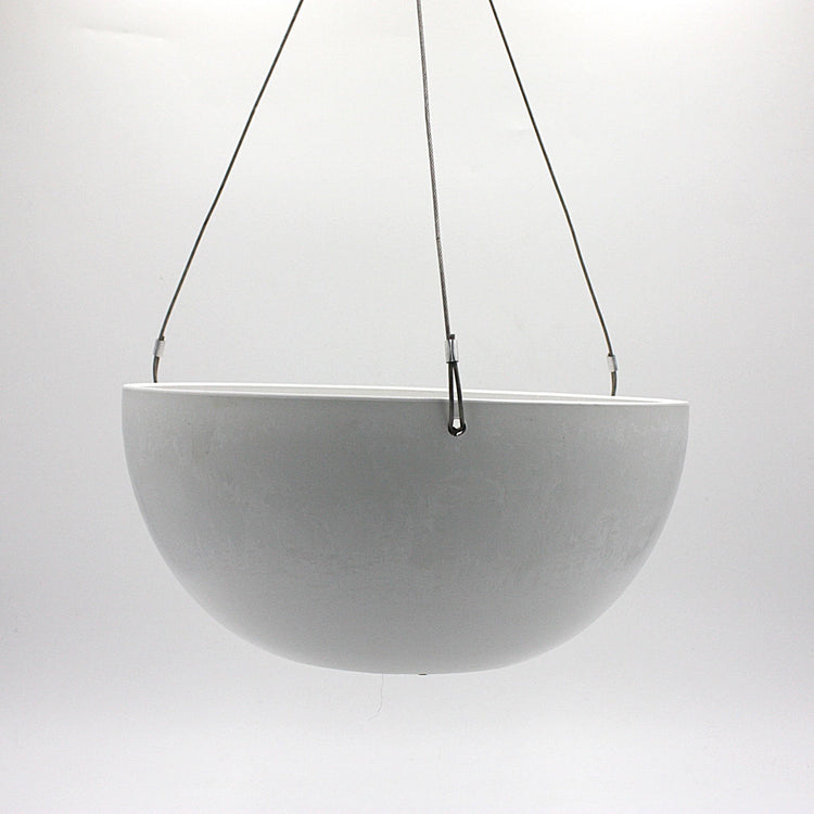A hanging planter suspended by marine wire against a plain white background. Made from recycled plastic. Shown in White Stone