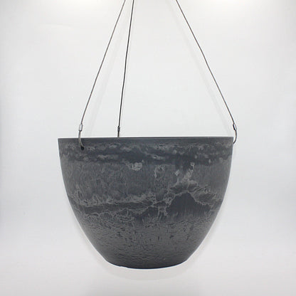 A dark gray hanging planter with a textured, marbled surface pattern, suspended by marine wire against a plain white background. Made from recycled plastic. Shown in Arctic Stone