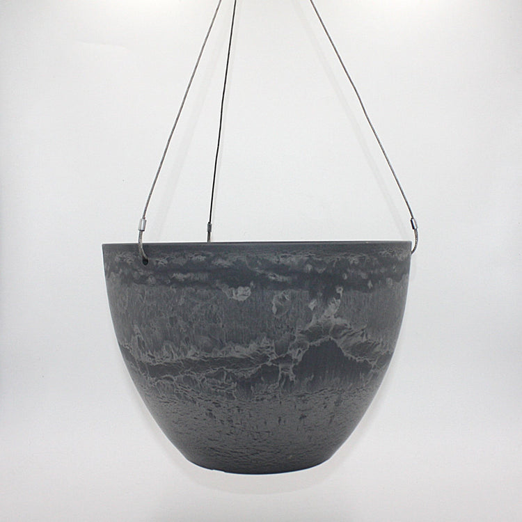 A dark gray hanging planter with a textured, marbled surface pattern, suspended by marine wire against a plain white background. Made from recycled plastic. Shown in Arctic Stone