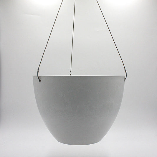 A hanging planter suspended by marine wire against a plain white background. Made from recycled plastic. Shown in White Stone