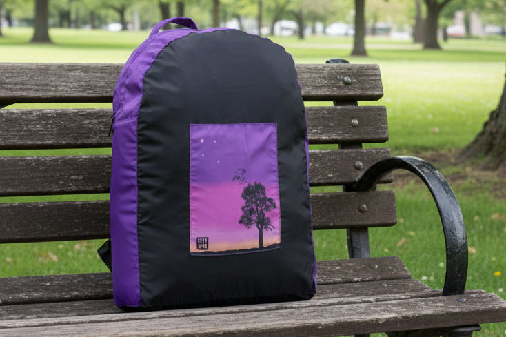 Sunset variant ONYA 100% recycled plastic backpack on a park bench 