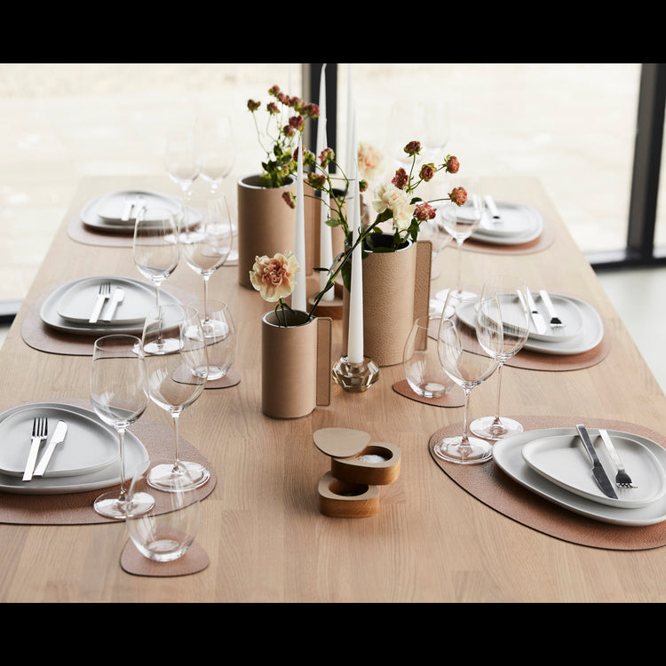 Curve recycled leather coaster featuring the signature LIND DNA hippo texture on a table set with matching placemats, crockery, cutlery, glassware and a table centrepiece.
