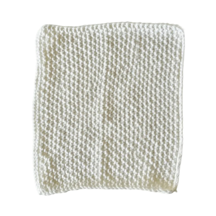 White handmade knitted dishcloth made from absorbent recycled cotton for kitchen and bathroom use.