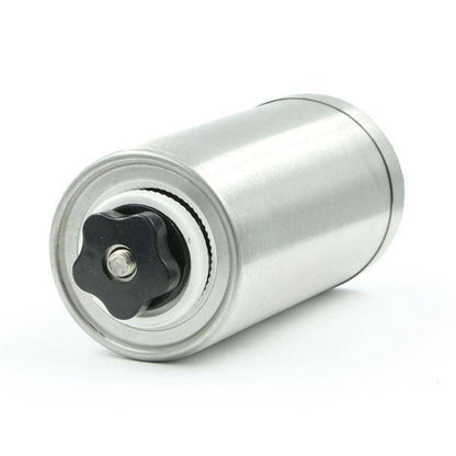 The inner components and adjustable ceramic burr mill mechanism of a manual coffee grinder arranged on a white background.